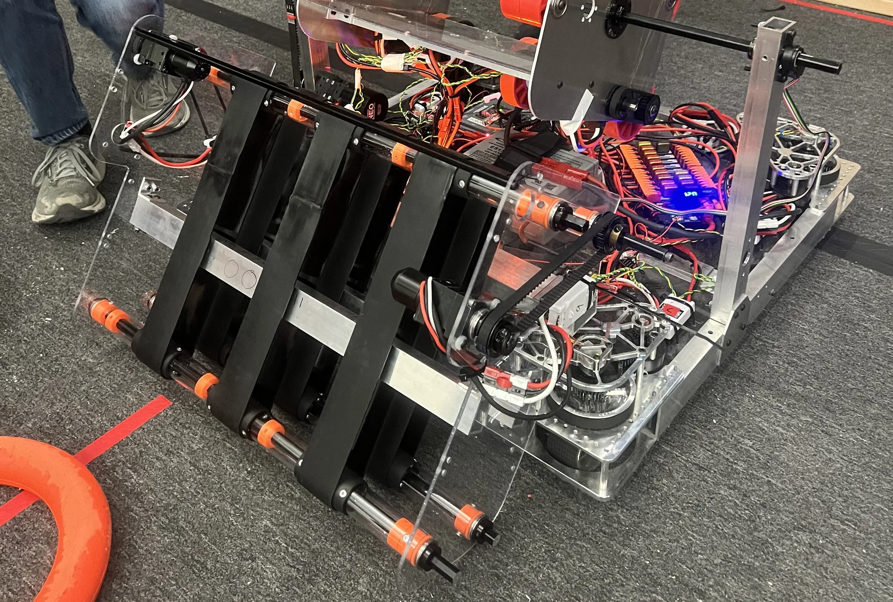 Intake V4: machined black polycarbonate intake with belts mounted on the robot chassis
