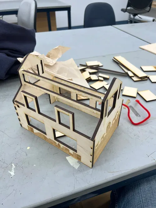 Barn shell with loose parts and paper towel on the table during assembly