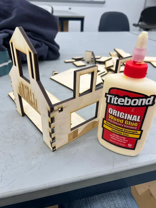 Barn walls being glued with a bottle of Titebond wood glue in the foreground