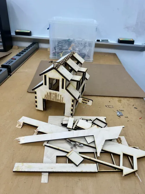 Barn on the workbench next to a pile of leftover plywood offcuts from the sheet