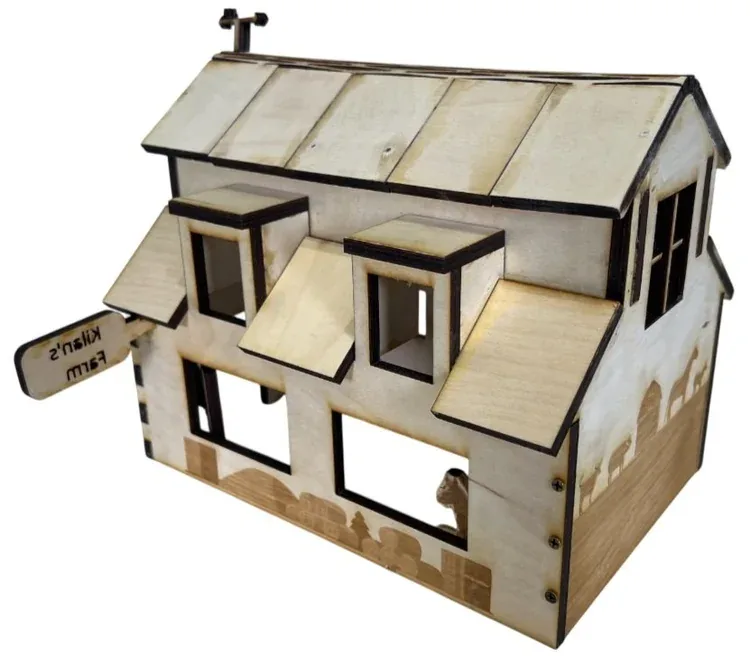 Finished barn from the side showing the slatted lattice roof, dormer windows and engraved animal silhouettes