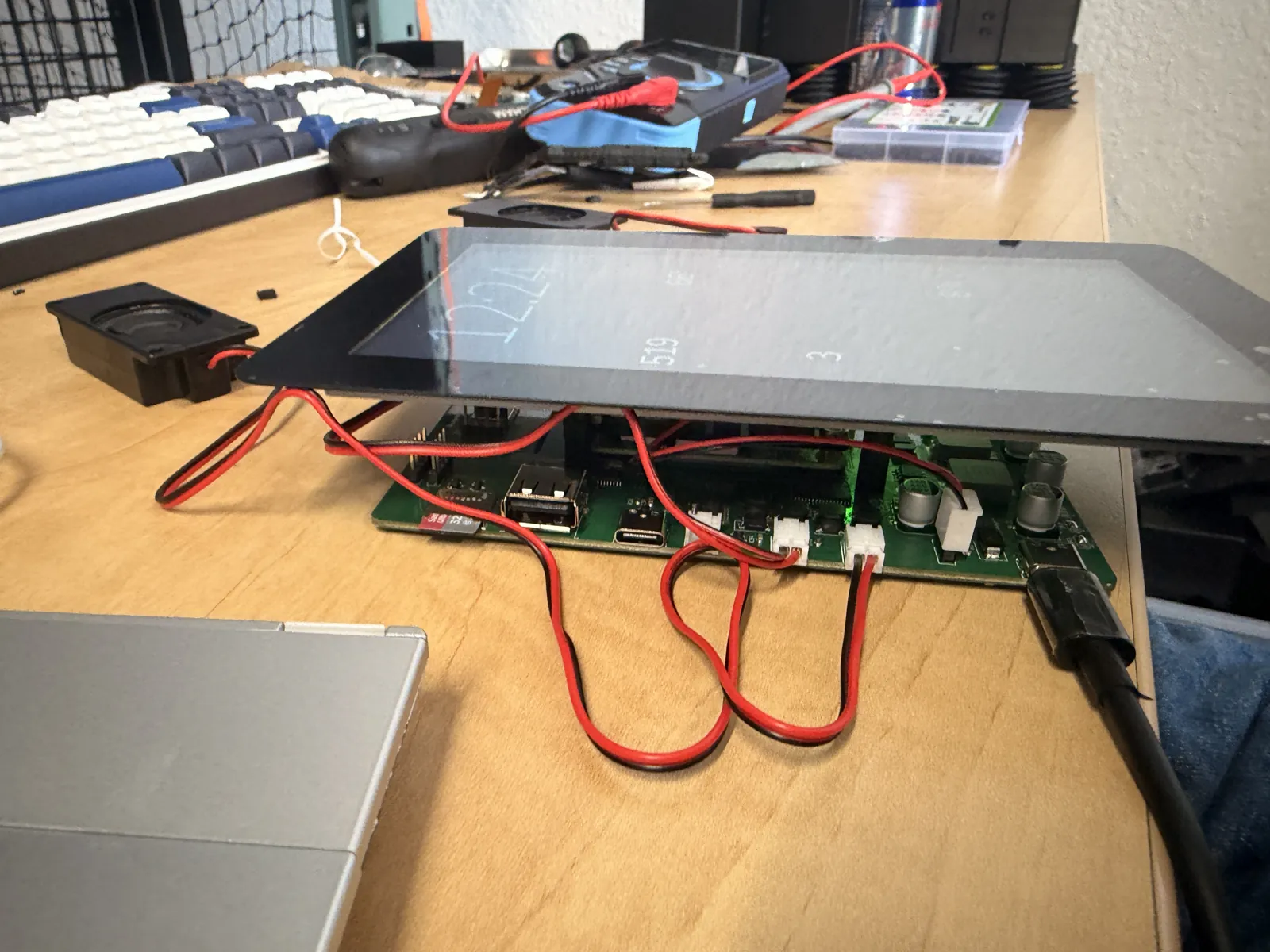 Bring-up bench with the Touch Display 2 connected to the board by its ribbon cables and a serial adapter
