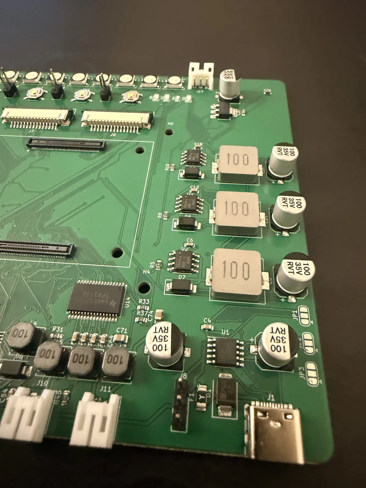 Angled close-up of the three TPS5430 buck converters with their inductors and electrolytic capacitors