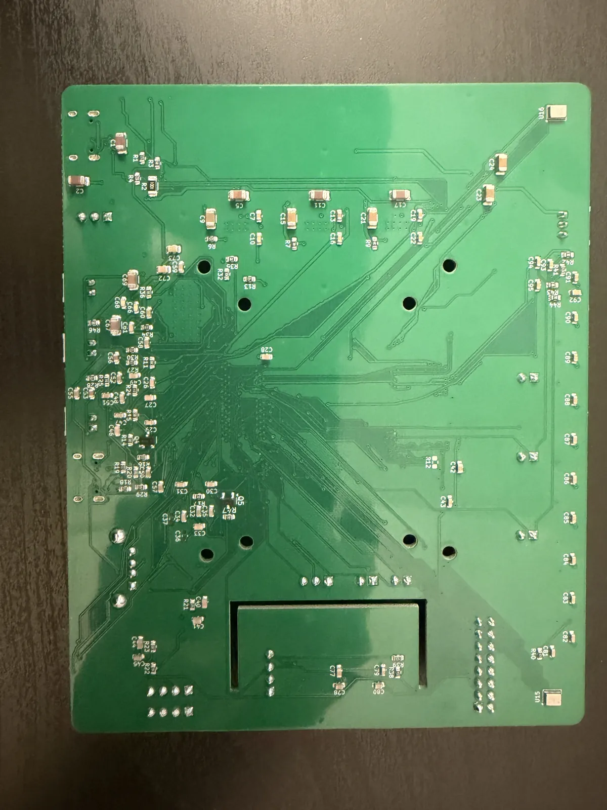 Bottom side of the rev A HomeDeck board showing the small passives and the two microphone ports