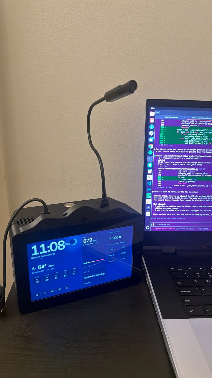 The finished HomeDeck on a desk showing the home screen, with a USB microphone on a gooseneck standing behind it and a laptop beside it