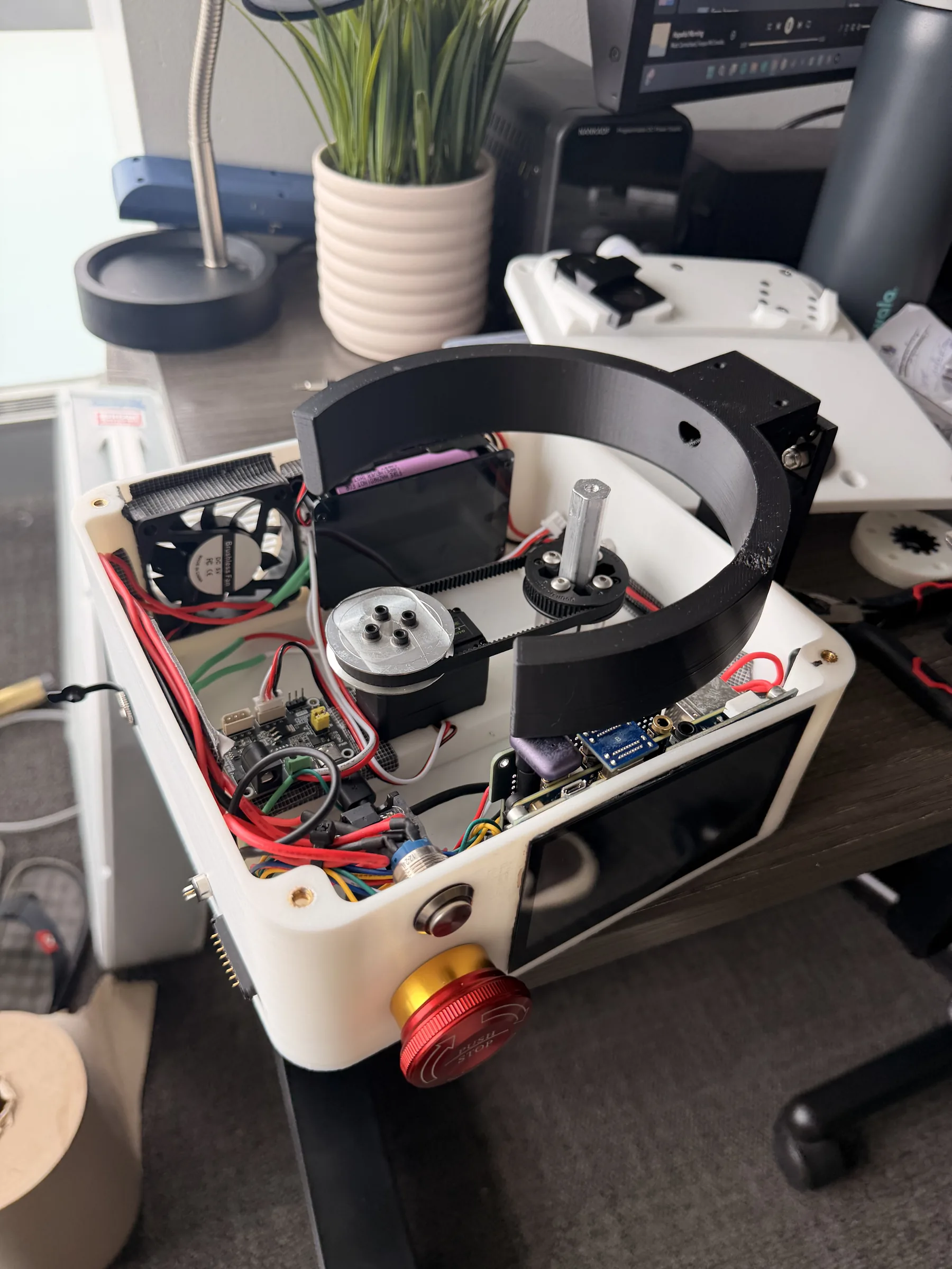 Top-down view of the V3 device with its onboard display and control electronics next to the folded plate holder