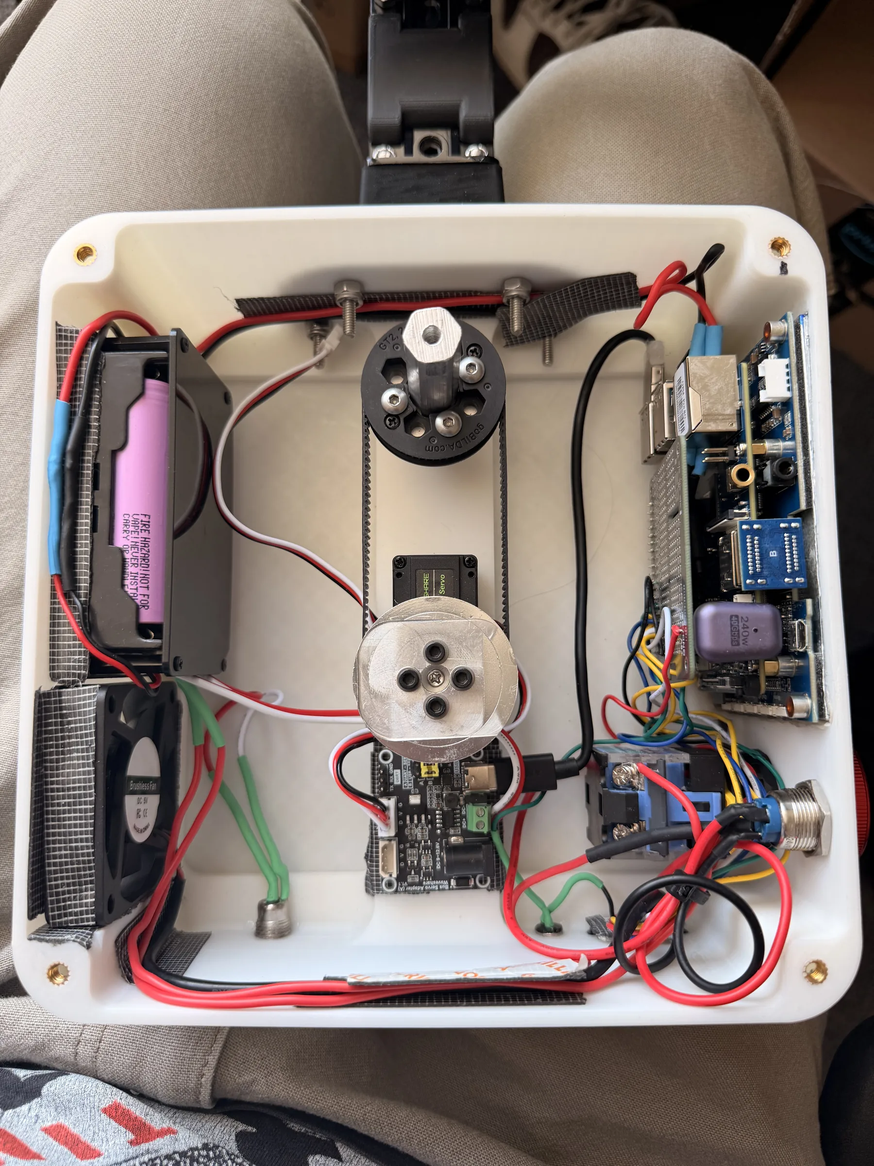 Inside the open V3 enclosure: servo motors, controller boards, battery and wiring routed to the external control ports