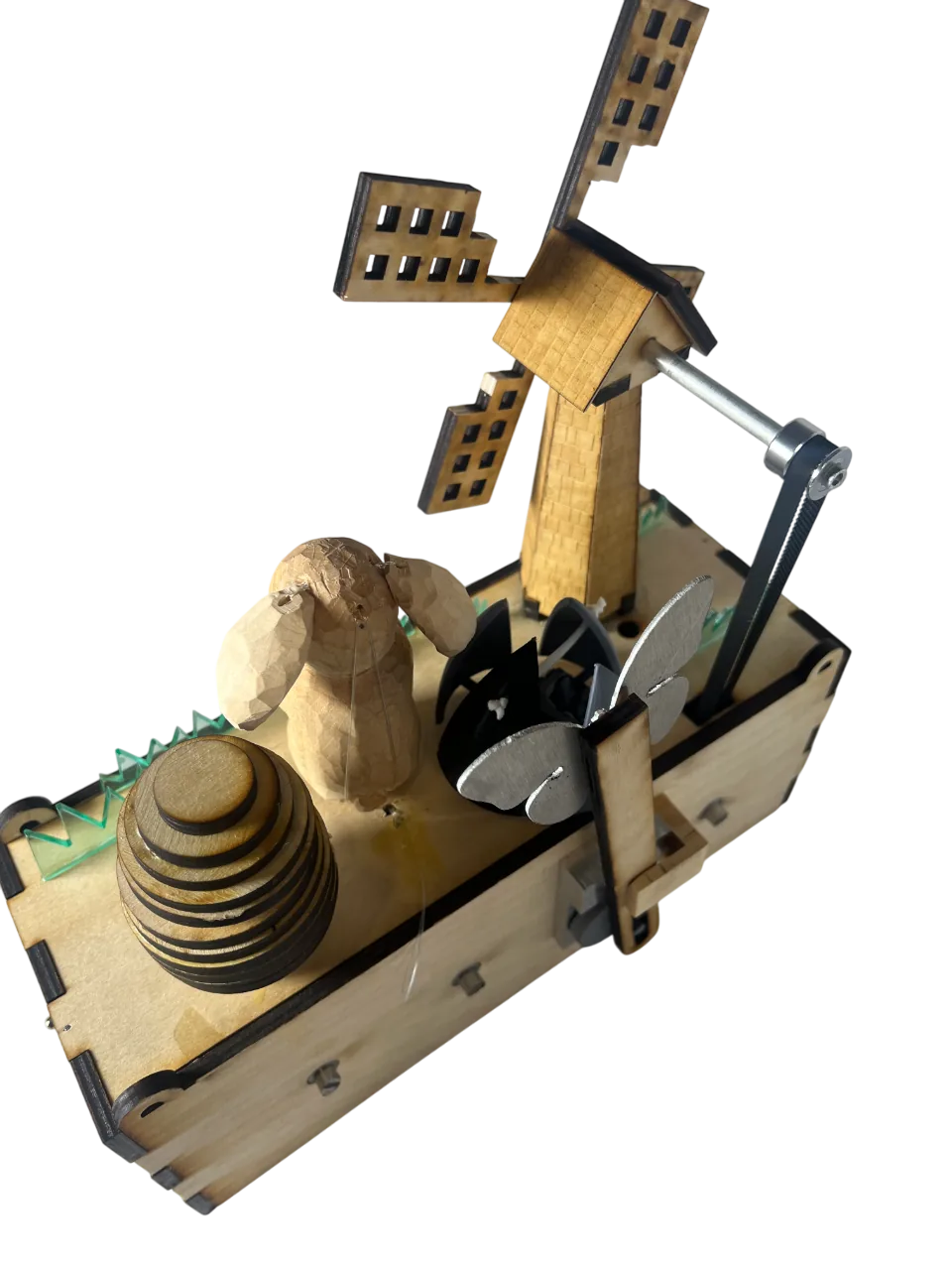 Early assembly of the sculpture with the windmill, bunny, egg and butterfly packed closely together on top of the box